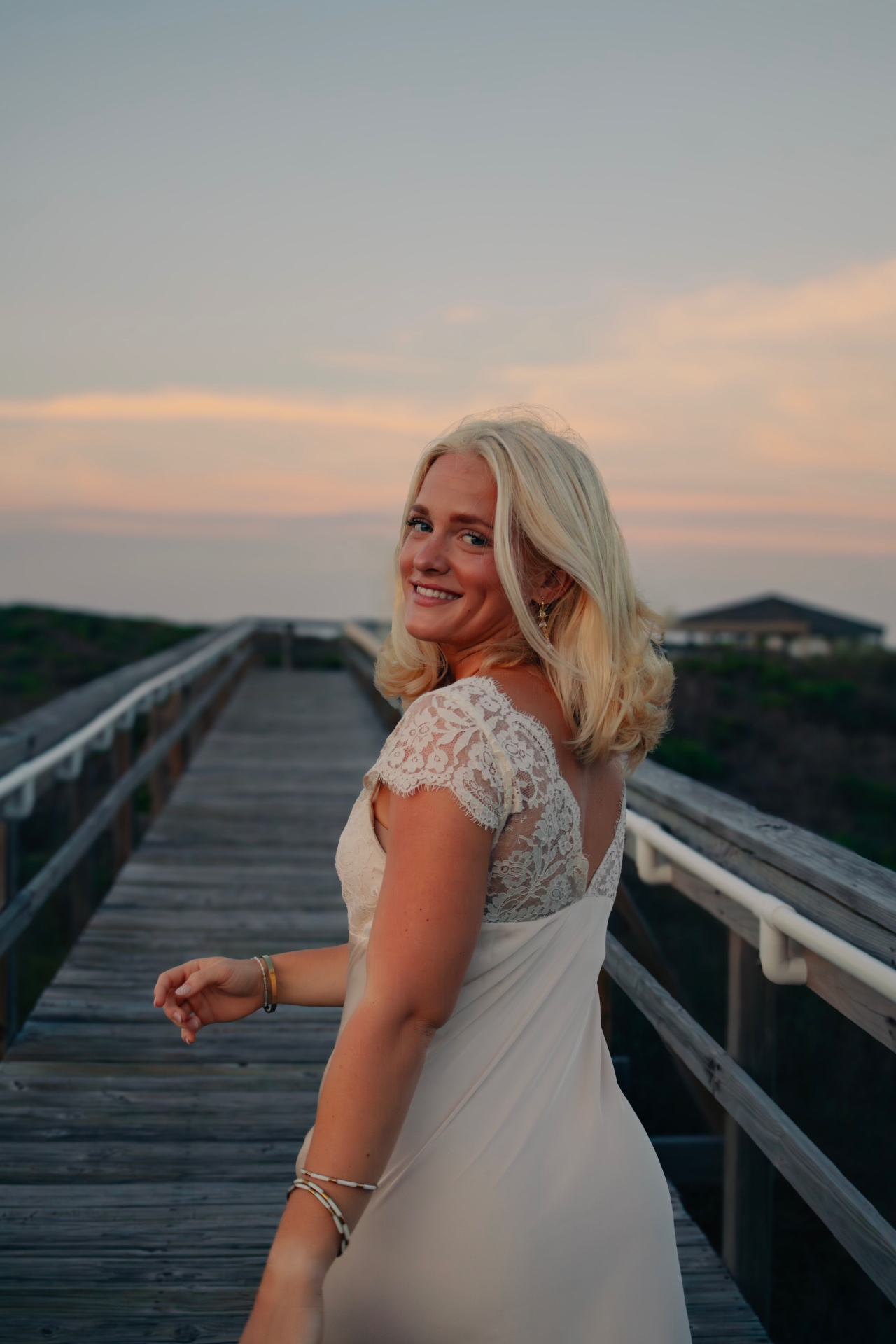 Senior portrait on the boardwalk at sunset